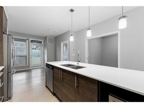 105-2231 Mahogany Boulevard Se, Calgary, AB - Indoor Photo Showing Kitchen With Double Sink