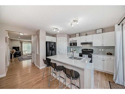 91 Arbour Meadows Close Nw, Calgary, AB - Indoor Photo Showing Kitchen With Double Sink