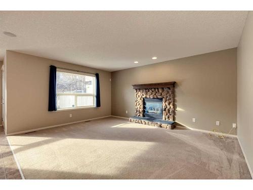 41 Eversyde Close Sw, Calgary, AB - Indoor Photo Showing Living Room With Fireplace