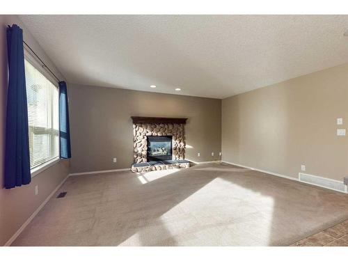 41 Eversyde Close Sw, Calgary, AB - Indoor Photo Showing Living Room With Fireplace