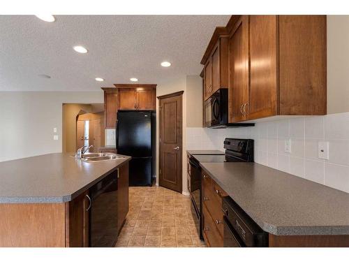 41 Eversyde Close Sw, Calgary, AB - Indoor Photo Showing Kitchen With Double Sink