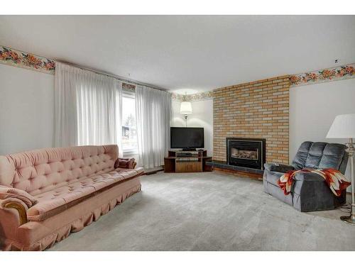 9628 Alcott Road Se, Calgary, AB - Indoor Photo Showing Living Room With Fireplace