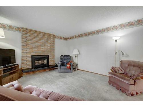 9628 Alcott Road Se, Calgary, AB - Indoor Photo Showing Living Room With Fireplace