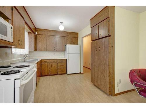 9628 Alcott Road Se, Calgary, AB - Indoor Photo Showing Kitchen With Double Sink