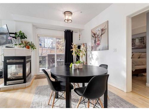 323-1800 14A Street Sw, Calgary, AB - Indoor Photo Showing Dining Room With Fireplace