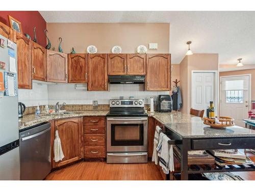 23-12 Woodside Rise Nw, Airdrie, AB - Indoor Photo Showing Kitchen With Double Sink