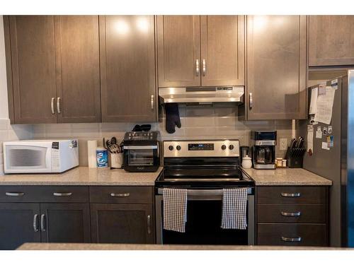 212-30 Shawnee Common Sw, Calgary, AB - Indoor Photo Showing Kitchen With Stainless Steel Kitchen