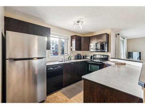 3121-16969 24 Street Sw, Calgary, AB - Indoor Photo Showing Kitchen With Double Sink