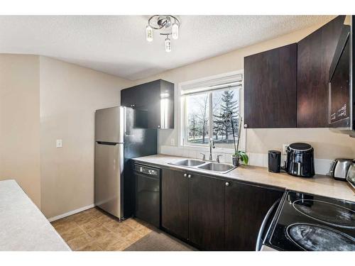 3121-16969 24 Street Sw, Calgary, AB - Indoor Photo Showing Kitchen With Double Sink