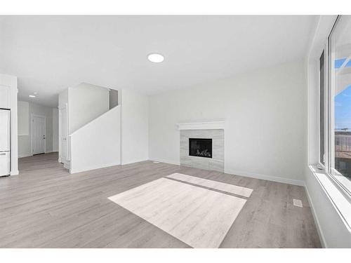 696 Reynolds Crescent Sw, Airdrie, AB - Indoor Photo Showing Living Room With Fireplace