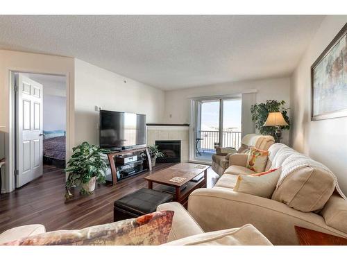 1408-10 Prestwick Bay Se, Calgary, AB - Indoor Photo Showing Living Room With Fireplace