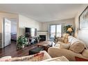 1408-10 Prestwick Bay Se, Calgary, AB  - Indoor Photo Showing Living Room With Fireplace 