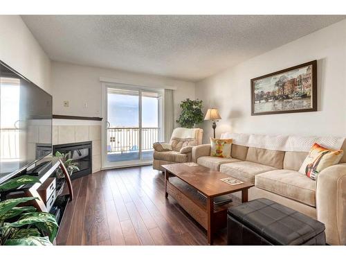 1408-10 Prestwick Bay Se, Calgary, AB - Indoor Photo Showing Living Room With Fireplace