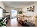 1408-10 Prestwick Bay Se, Calgary, AB  - Indoor Photo Showing Living Room With Fireplace 