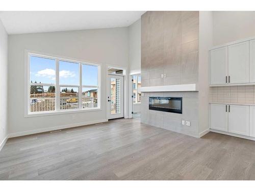 348 Rivercrest View, Cochrane, AB - Indoor Photo Showing Living Room With Fireplace