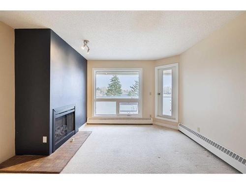 403-3747 42 Street Nw, Calgary, AB - Indoor Photo Showing Other Room With Fireplace