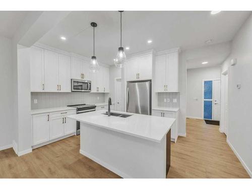 223 Willow Place, Cochrane, AB - Indoor Photo Showing Kitchen With Stainless Steel Kitchen With Double Sink With Upgraded Kitchen