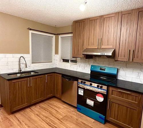 98 Hidden Spring Circle Nw, Calgary, AB - Indoor Photo Showing Kitchen With Double Sink