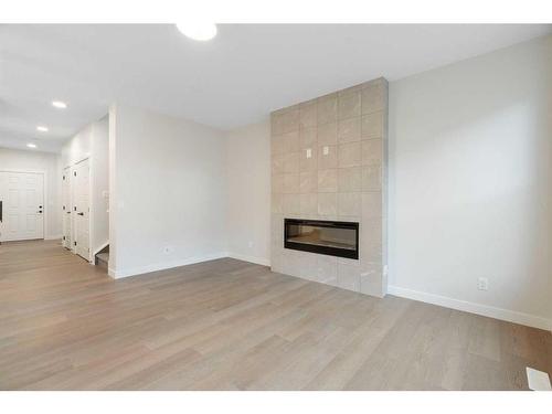 275 Rivercrest Way, Cochrane, AB - Indoor Photo Showing Living Room With Fireplace