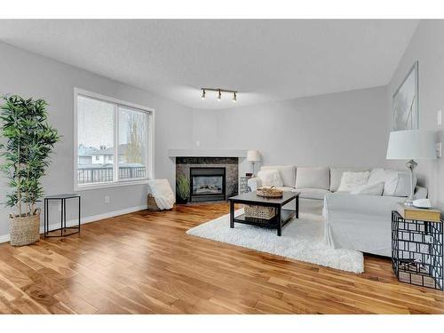 446 Panamount Boulevard Nw, Calgary, AB - Indoor Photo Showing Living Room With Fireplace