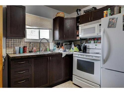 719 Poplar Road Sw, Calgary, AB - Indoor Photo Showing Kitchen With Double Sink