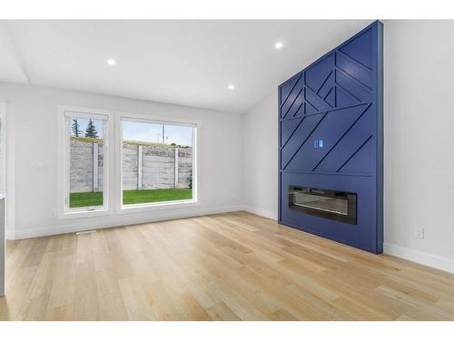 10 Glenmore Green Sw, Calgary, AB - Indoor Photo Showing Living Room With Fireplace