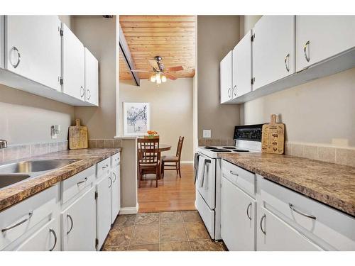 105-7416 Hunterview Drive Nw, Calgary, AB - Indoor Photo Showing Kitchen With Double Sink