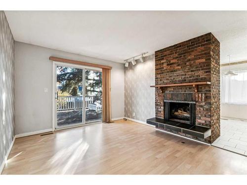 352 Maddock Crescent Ne, Calgary, AB - Indoor Photo Showing Living Room With Fireplace