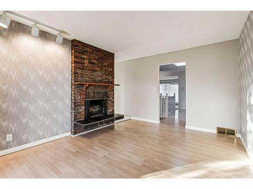 352 Maddock Crescent Ne, Calgary, AB - Indoor Photo Showing Living Room With Fireplace