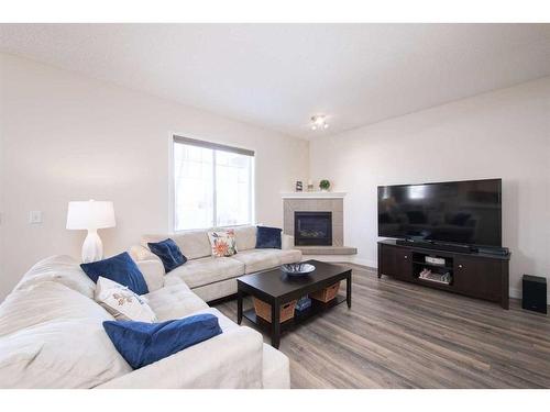 110-2 Westbury Place Sw, Calgary, AB - Indoor Photo Showing Living Room With Fireplace