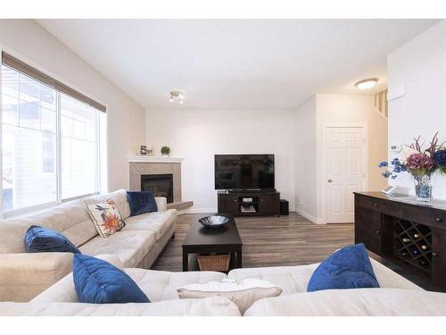 110-2 Westbury Place Sw, Calgary, AB - Indoor Photo Showing Living Room With Fireplace