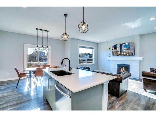 937 Midtown Avenue Sw, Airdrie, AB - Indoor Photo Showing Kitchen With Fireplace With Upgraded Kitchen