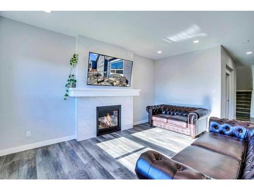 937 Midtown Avenue Sw, Airdrie, AB - Indoor Photo Showing Living Room With Fireplace