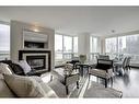 2113-222 Riverfront Avenue Sw, Calgary, AB  - Indoor Photo Showing Living Room With Fireplace 