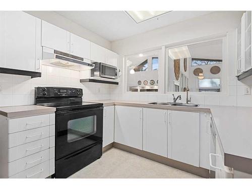 5711 Lawson Place Sw, Calgary, AB - Indoor Photo Showing Kitchen With Double Sink