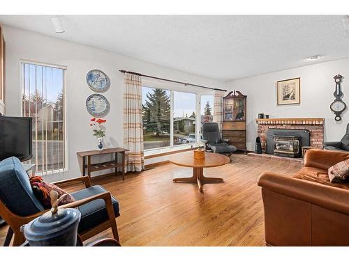 5711 Lawson Place Sw, Calgary, AB - Indoor Photo Showing Living Room With Fireplace