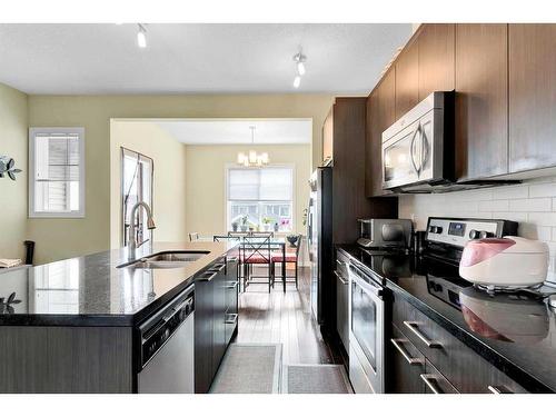 107-300 Marina Drive, Chestermere, AB - Indoor Photo Showing Kitchen With Stainless Steel Kitchen With Double Sink With Upgraded Kitchen