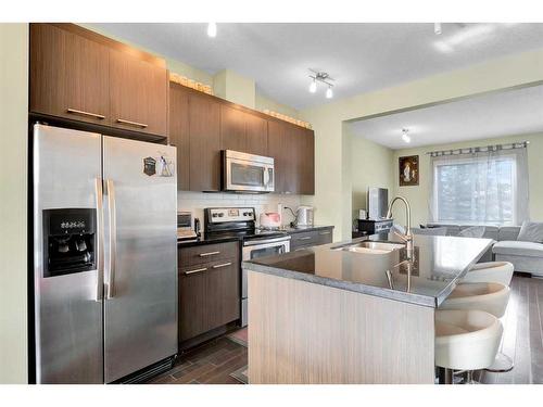 107-300 Marina Drive, Chestermere, AB - Indoor Photo Showing Kitchen With Stainless Steel Kitchen With Double Sink