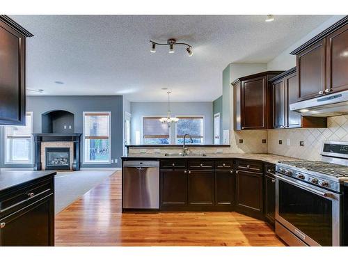 86 Cresthaven View Sw, Calgary, AB - Indoor Photo Showing Kitchen With Fireplace With Stainless Steel Kitchen With Double Sink