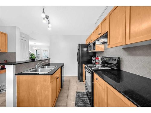 6 Luxstone Point Sw, Airdrie, AB - Indoor Photo Showing Kitchen With Double Sink