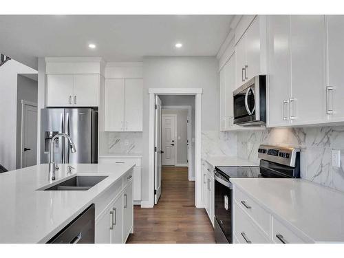 15 Legacy Reach View Se, Calgary, AB - Indoor Photo Showing Kitchen With Stainless Steel Kitchen With Double Sink With Upgraded Kitchen