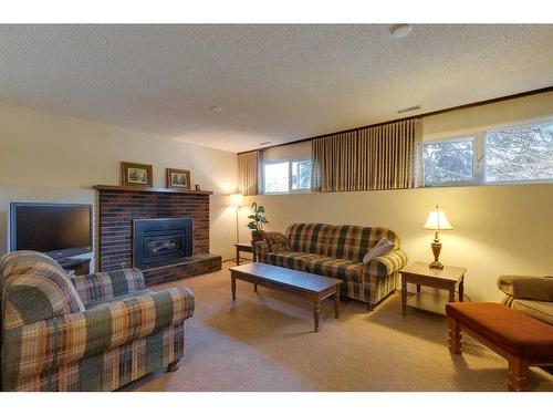 4911 Vantage Crescent Nw, Calgary, AB - Indoor Photo Showing Living Room With Fireplace