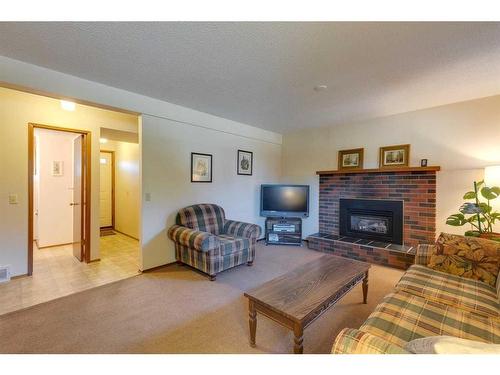 4911 Vantage Crescent Nw, Calgary, AB - Indoor Photo Showing Living Room With Fireplace