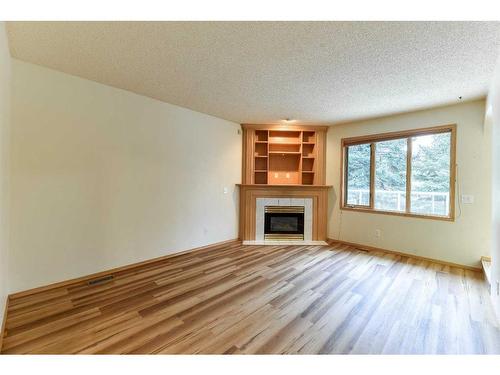 1045 Shawnee Drive Sw, Calgary, AB - Indoor Photo Showing Living Room With Fireplace