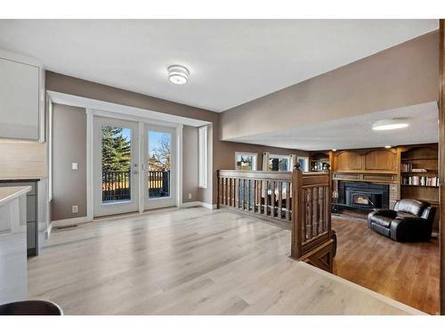 56 Woodfern Way Sw, Calgary, AB - Indoor With Fireplace