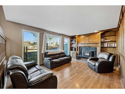 56 Woodfern Way Sw, Calgary, AB - Indoor Photo Showing Living Room With Fireplace