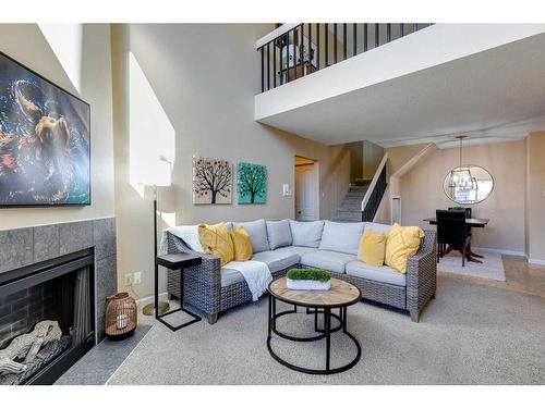 731-6400 Coach Hill Road Sw, Calgary, AB - Indoor Photo Showing Living Room With Fireplace