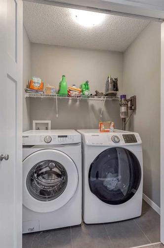 13 Willow Green Way, Cochrane, AB - Indoor Photo Showing Laundry Room