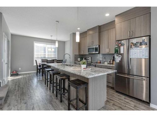 13 Willow Green Way, Cochrane, AB - Indoor Photo Showing Kitchen With Stainless Steel Kitchen With Upgraded Kitchen