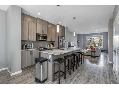 13 Willow Green Way, Cochrane, AB - Indoor Photo Showing Kitchen With Upgraded Kitchen